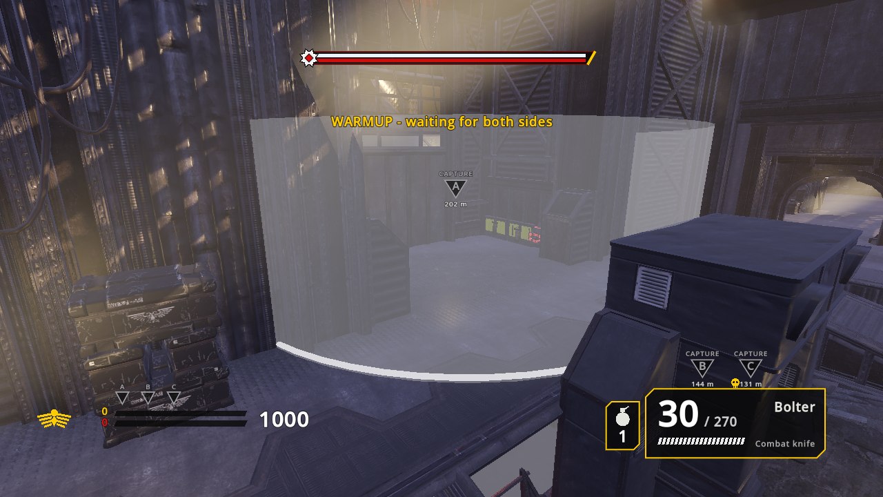 A factory hall with a translucent white cylinder marking the spawn-room barrier
